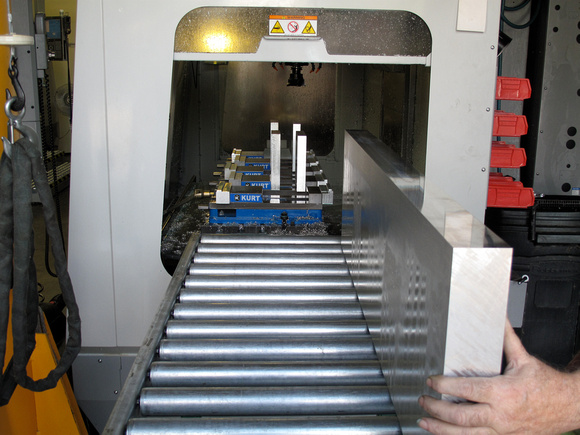 An Aluminum Bar Is Rolled Into A CNC Machine