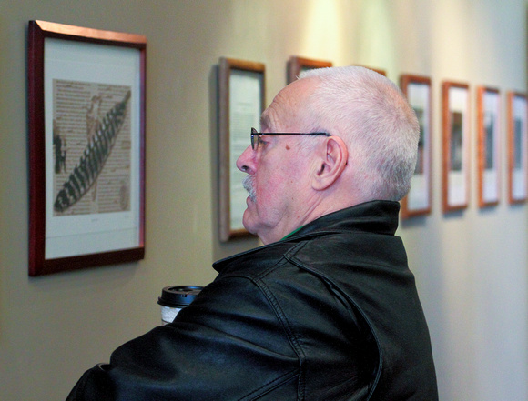 Man Looking at Photos, Iris Book Cafe